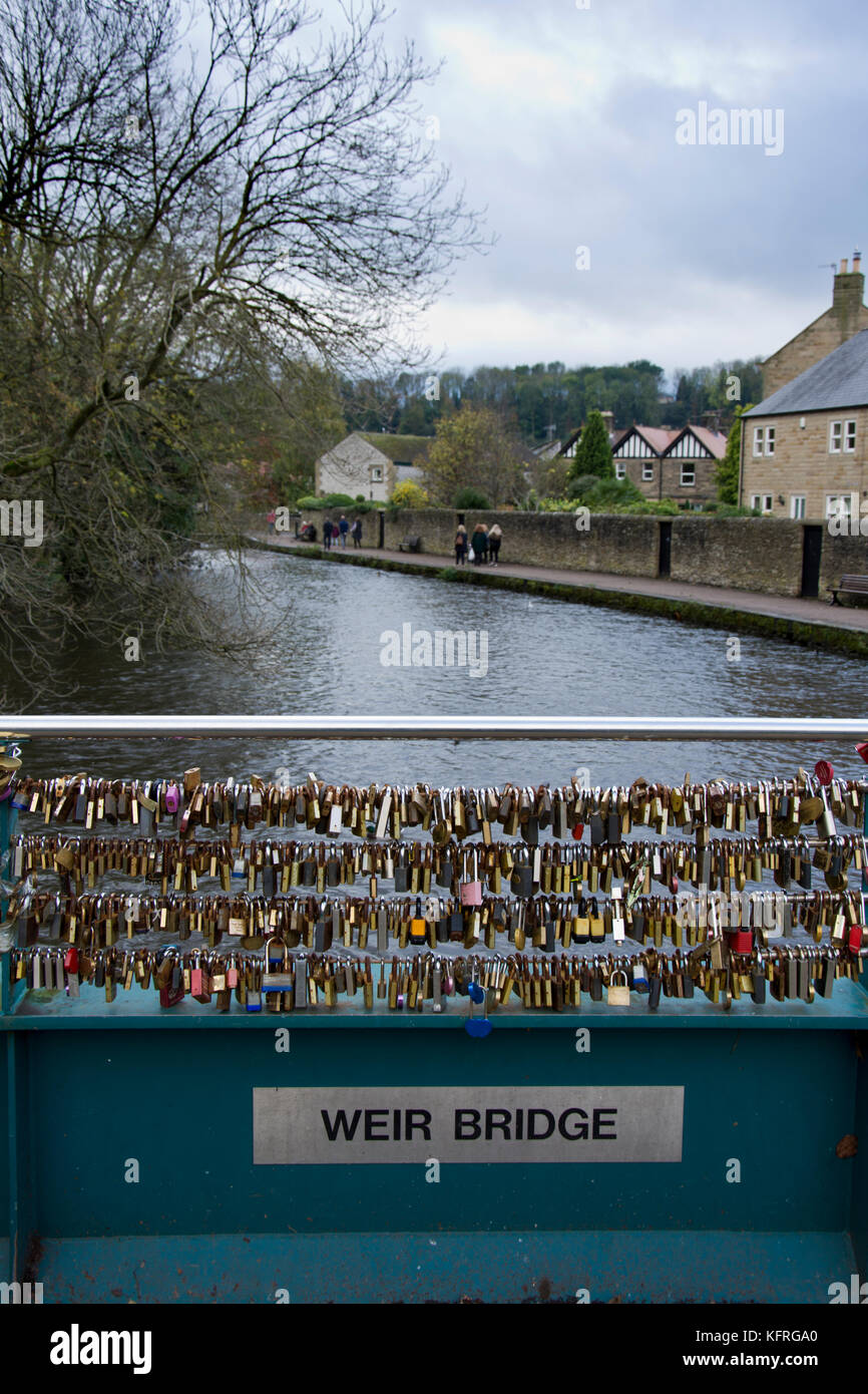 Love locks attached to Weir bridge, over the river Wye, Bakewell
