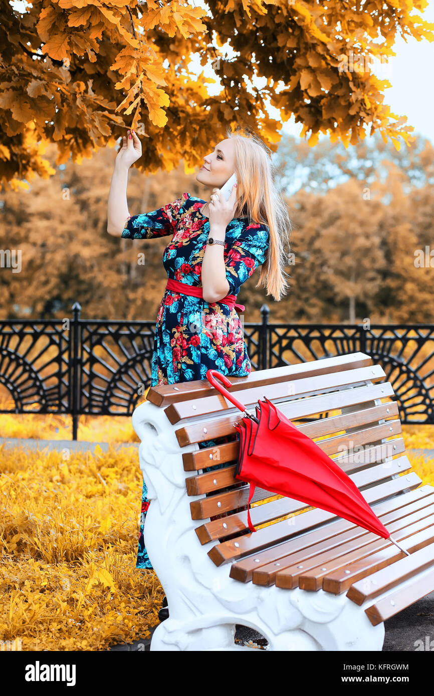 Girl in the street with an umbrella Stock Photo - Alamy