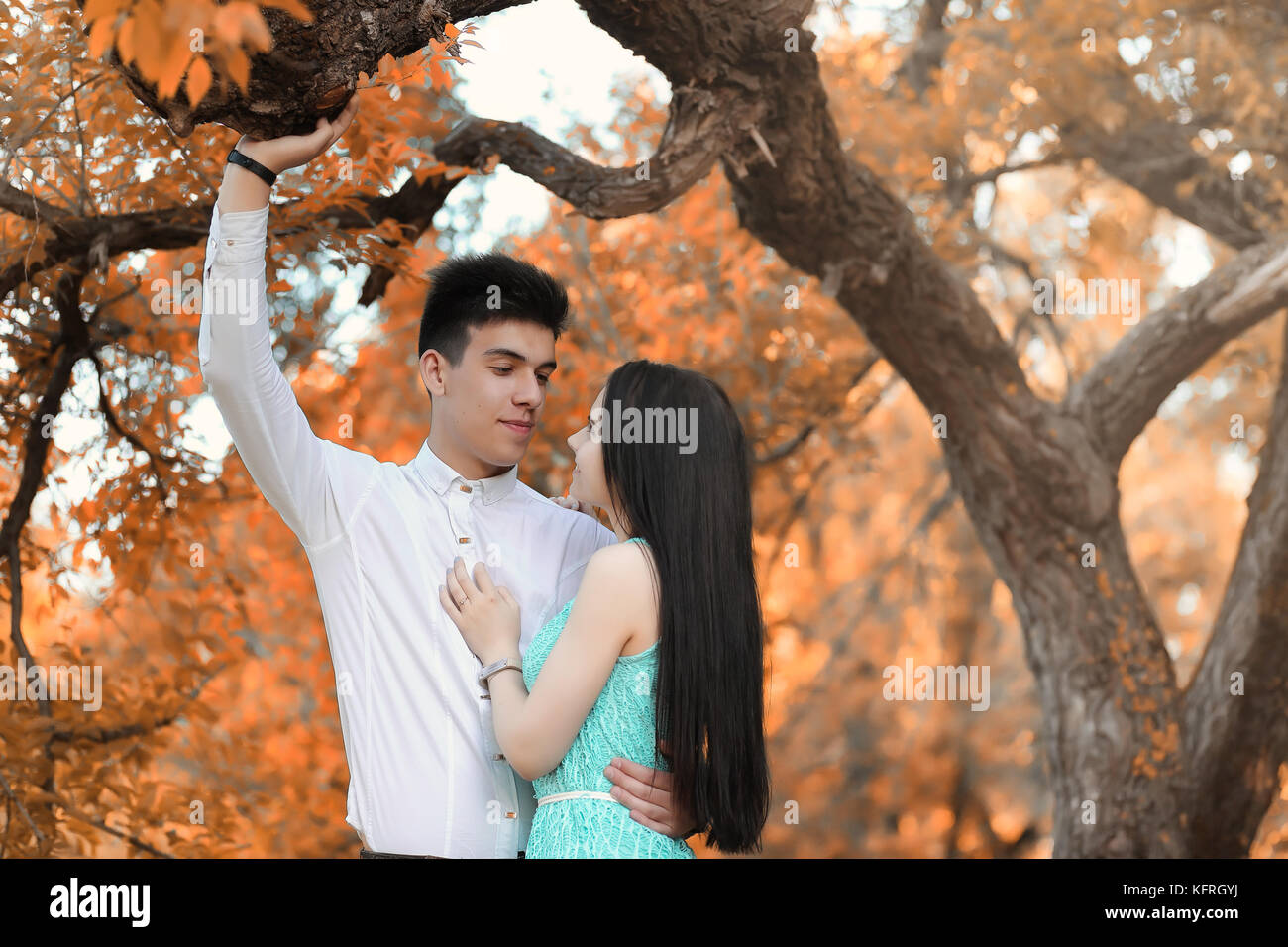 Young couple on a walk in autumn park Stock Photo - Alamy
