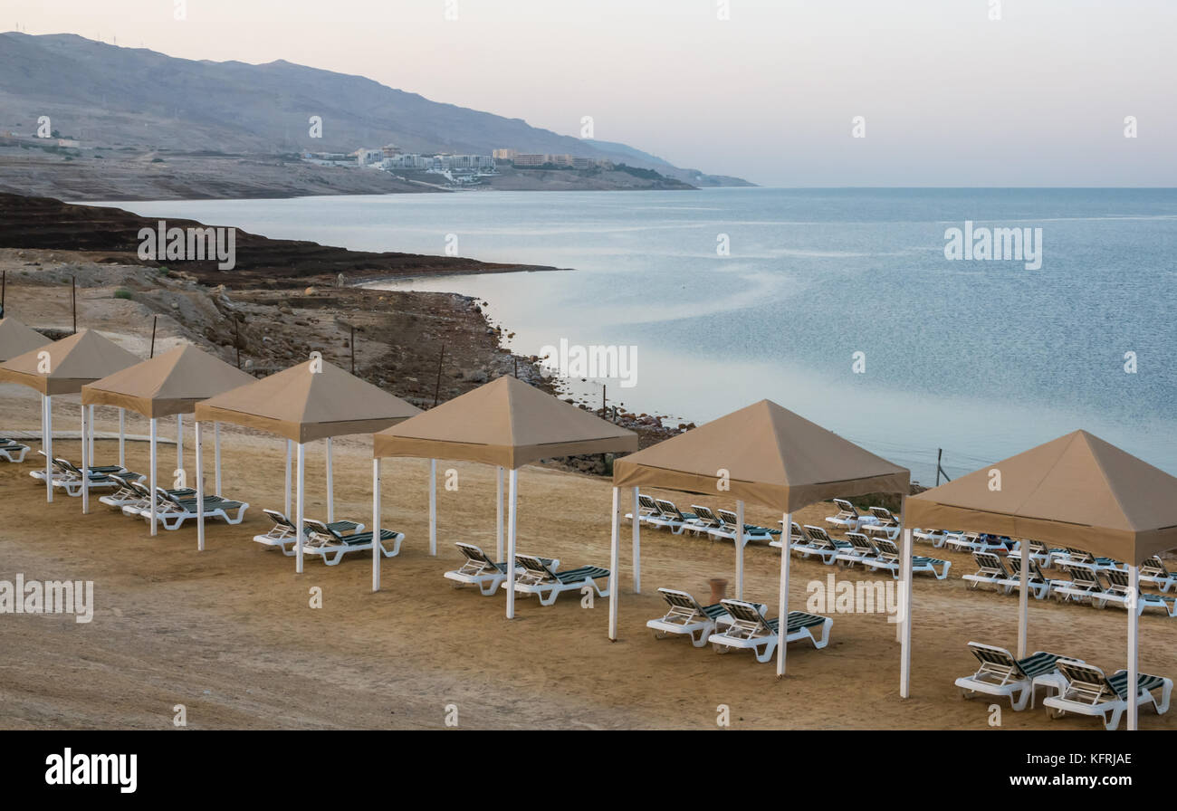 Early morning light at Holiday Inn Dead Sea resort, with empty beach sun loungers, Jordan, Middle East, and view over Dead Sea Stock Photo