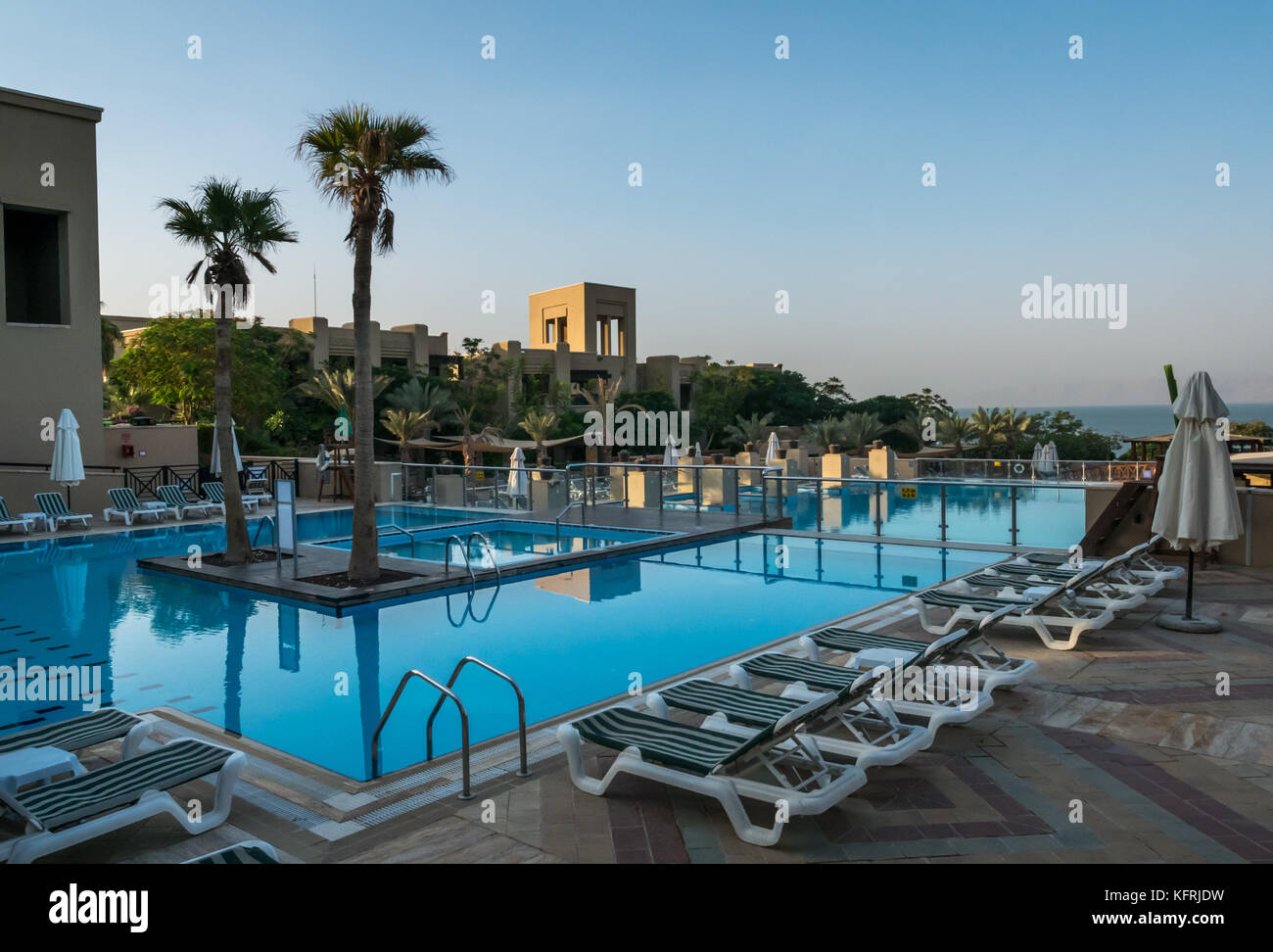 Early morning at the outdoor swimming pool complex, Holiday Inn Dead Sea beach resort, with no one in the pool, Jordan, Middle East Stock Photo