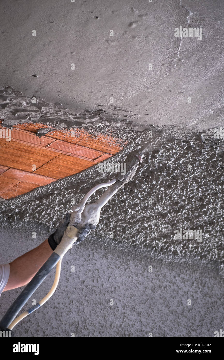 Construction Worker Applying Cement Plaster Coating On The