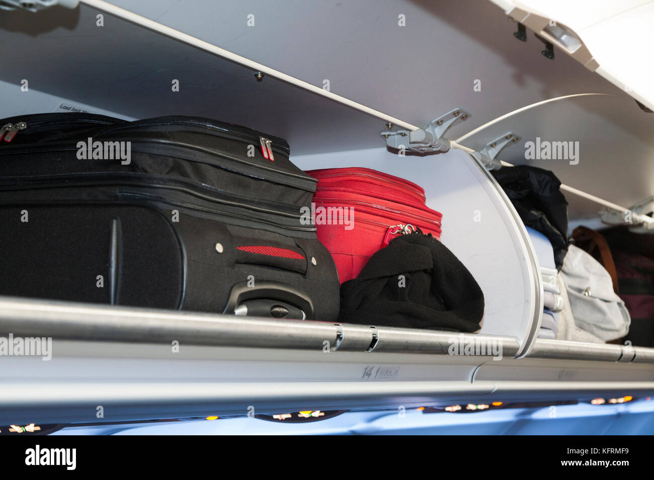 Overhead passenger locker lockers / compartment / compartments for stowing passengers bags cabin luggage; BA / British Airways Portugal flight. (76) Stock Photo