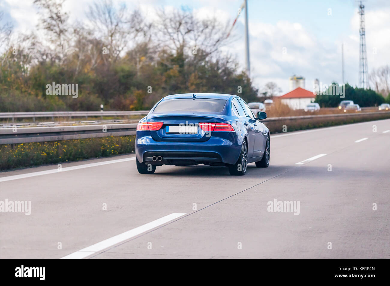 blue car drives on a german motorway Stock Photo