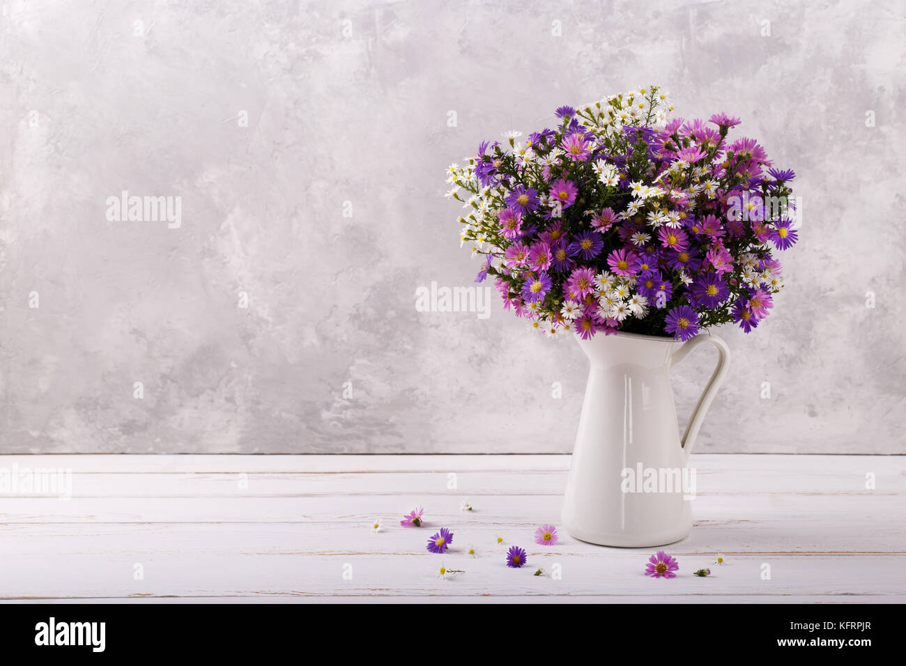 Bouquet Of Colorful Aster Flowers In A Pitcher On White Vintage Background With Copy Space Stock Photo Alamy