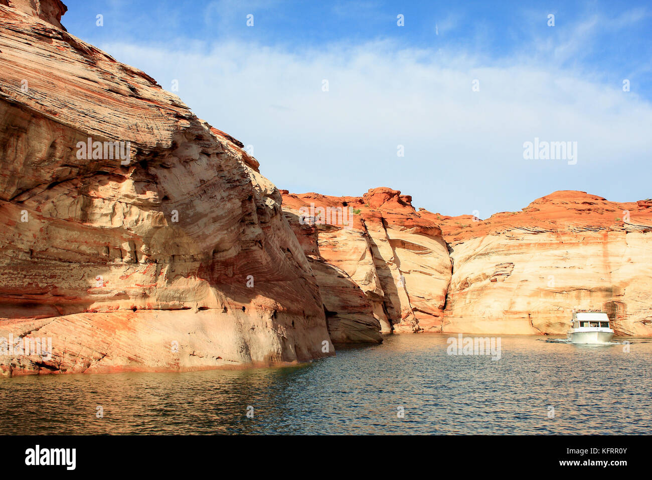 boat touring Lake Powell in Glen Canyon National Recreation Area Stock Photo