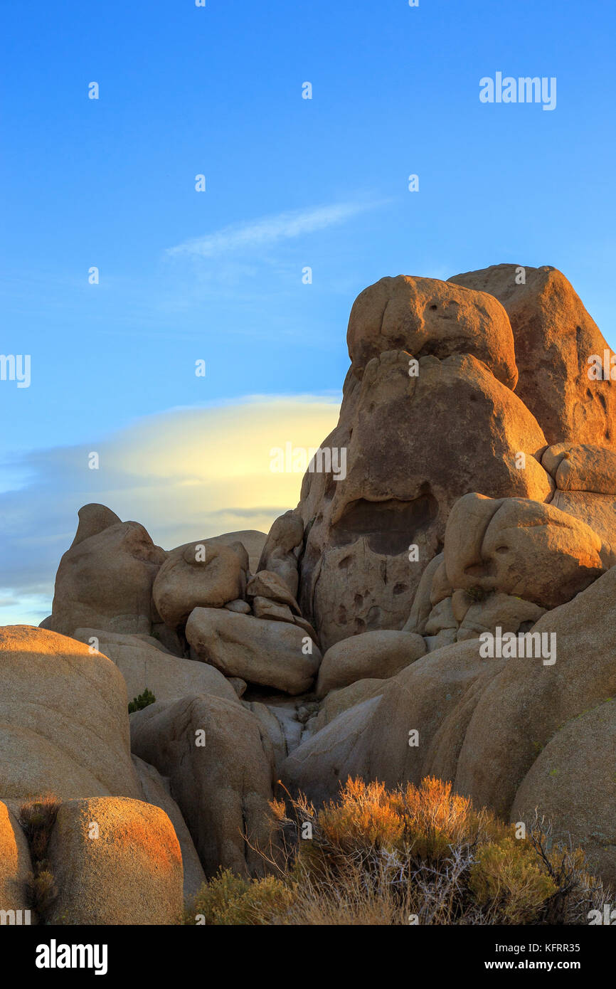Unique rock formation and lenticular clouds behind it at Joshua tree ...