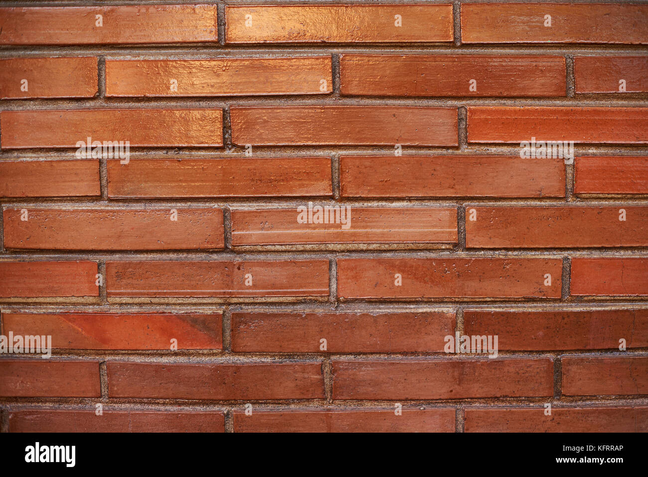 Pattern of long red bricks wall background. Brown block pattern surface Stock Photo