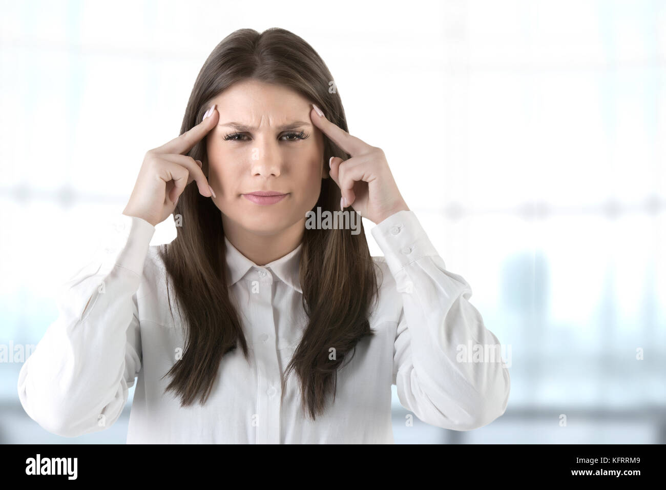 Woman suffering from an headache, holding her hand to the head Stock Photo