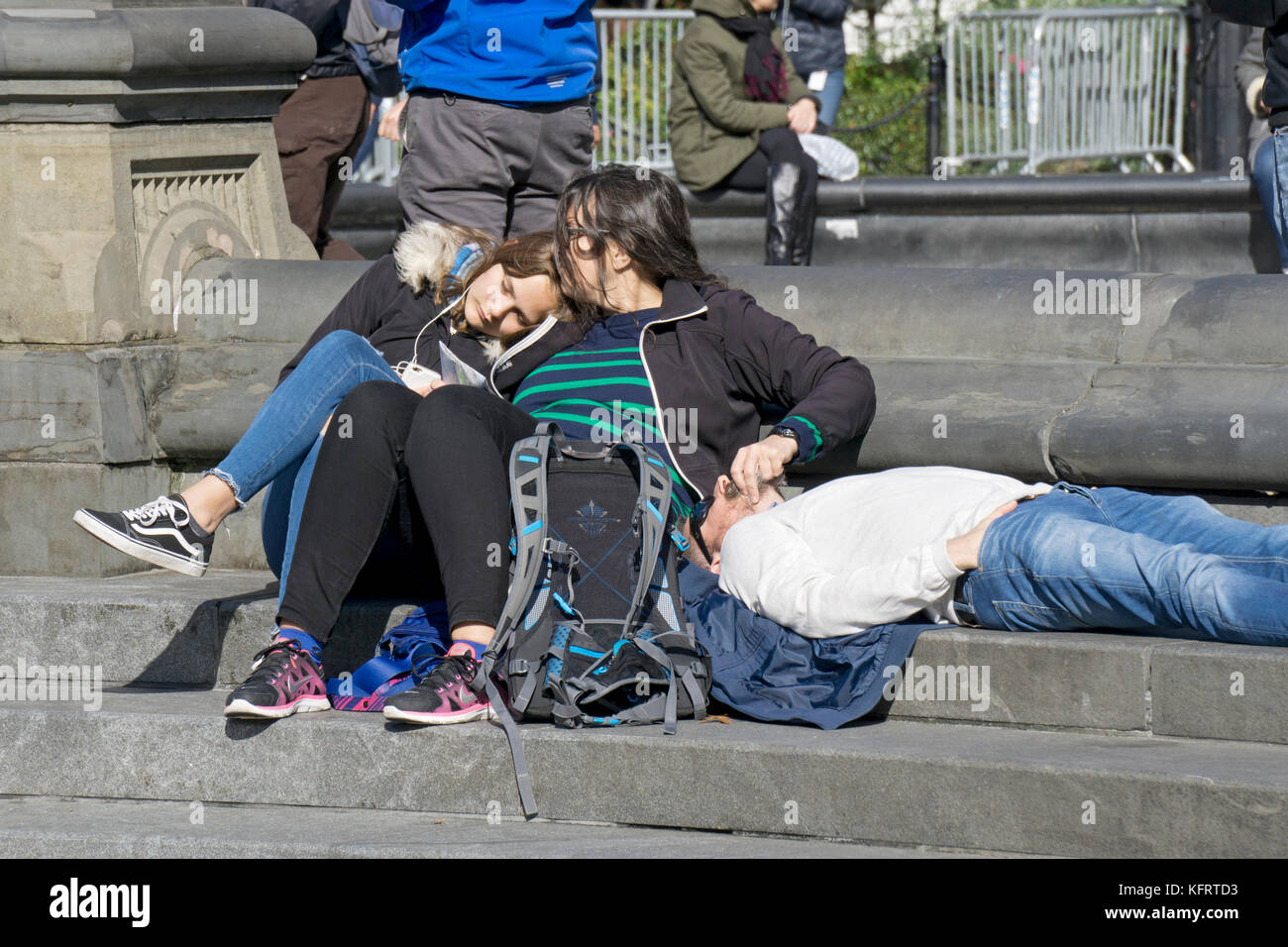 A tourist family resting and snuggling in Washington Square Park in Greenwich Village in Manhattan, New York City. Stock Photo