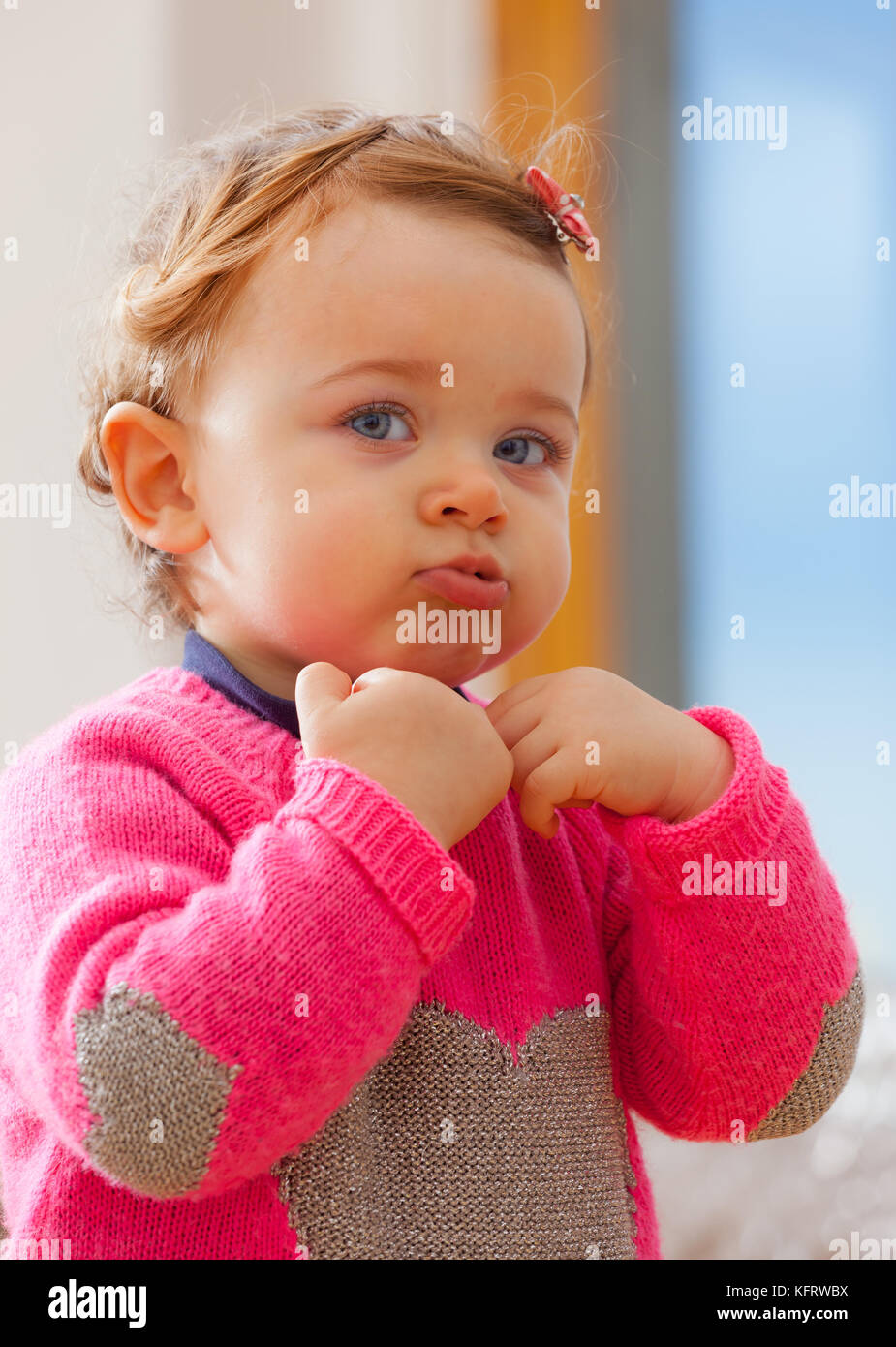 Toddler baby girl plays making bubbles with her mouth Stock Photo Alamy