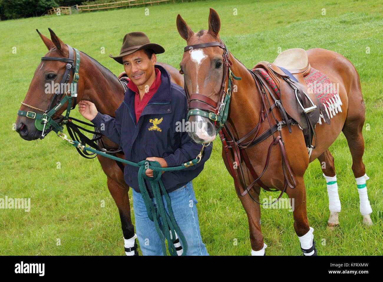 Martin Ephson with his polo ponies 'Vampiro' (white spot on head and red disc on bridle) and 'Jungle' at his home in Wiltshire. Stock Photo