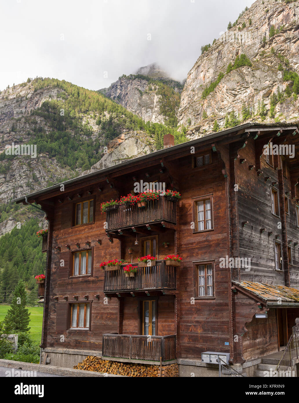 HERBRIGGEN, SWITZERLAND - Wooden house and cliffs. Stock Photo