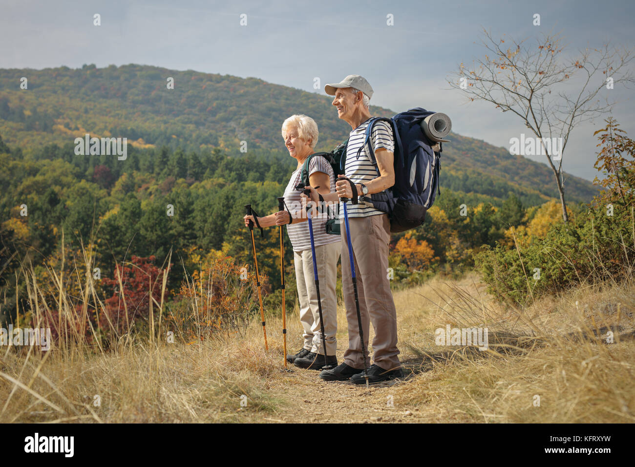 Full length profile shot of elderly hikers looking away outdoors Stock Photo