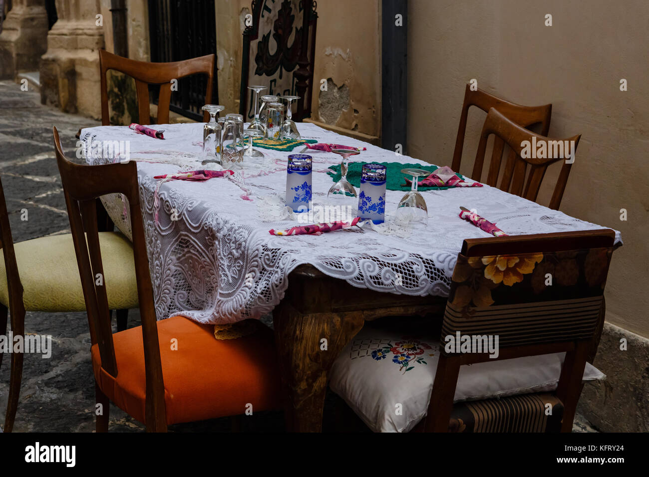 Beautifully served table from tavern on narrow street of Siracuse, Sicily, Italy Stock Photo