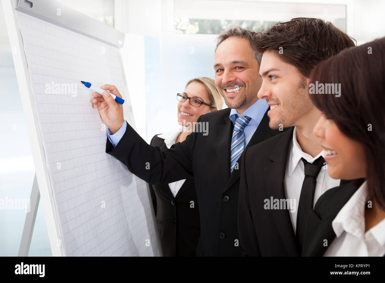 Group of business people looking at the graph on flipchart Stock Photo