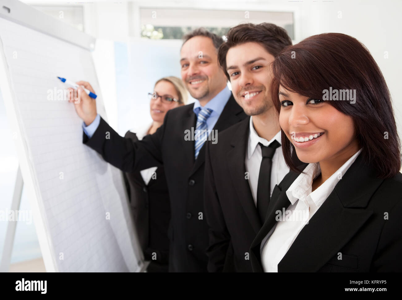 Group of business people looking at the graph on flipchart Stock Photo