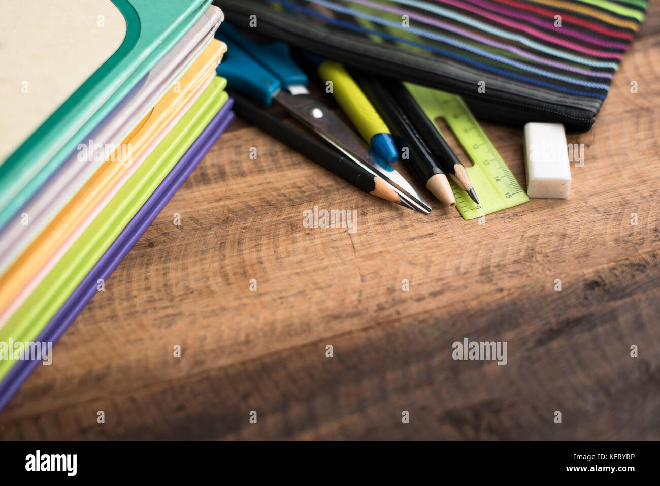 back to school concept - book,pen,ruler,eraser and pencil sharpener on a wooden table Stock Photo