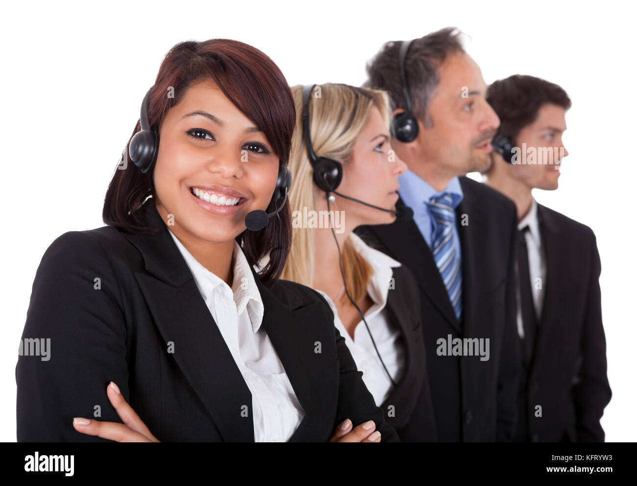 Confident business team with headset standing in a line against white background Stock Photo