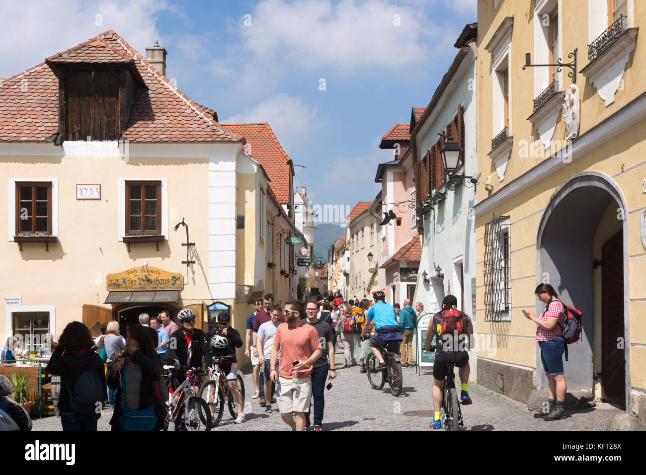 Tourists making their way along the Hauptstraße (main street) of Dürnstein, one of the most popular tourist destinations in the Wachau region Stock Photo