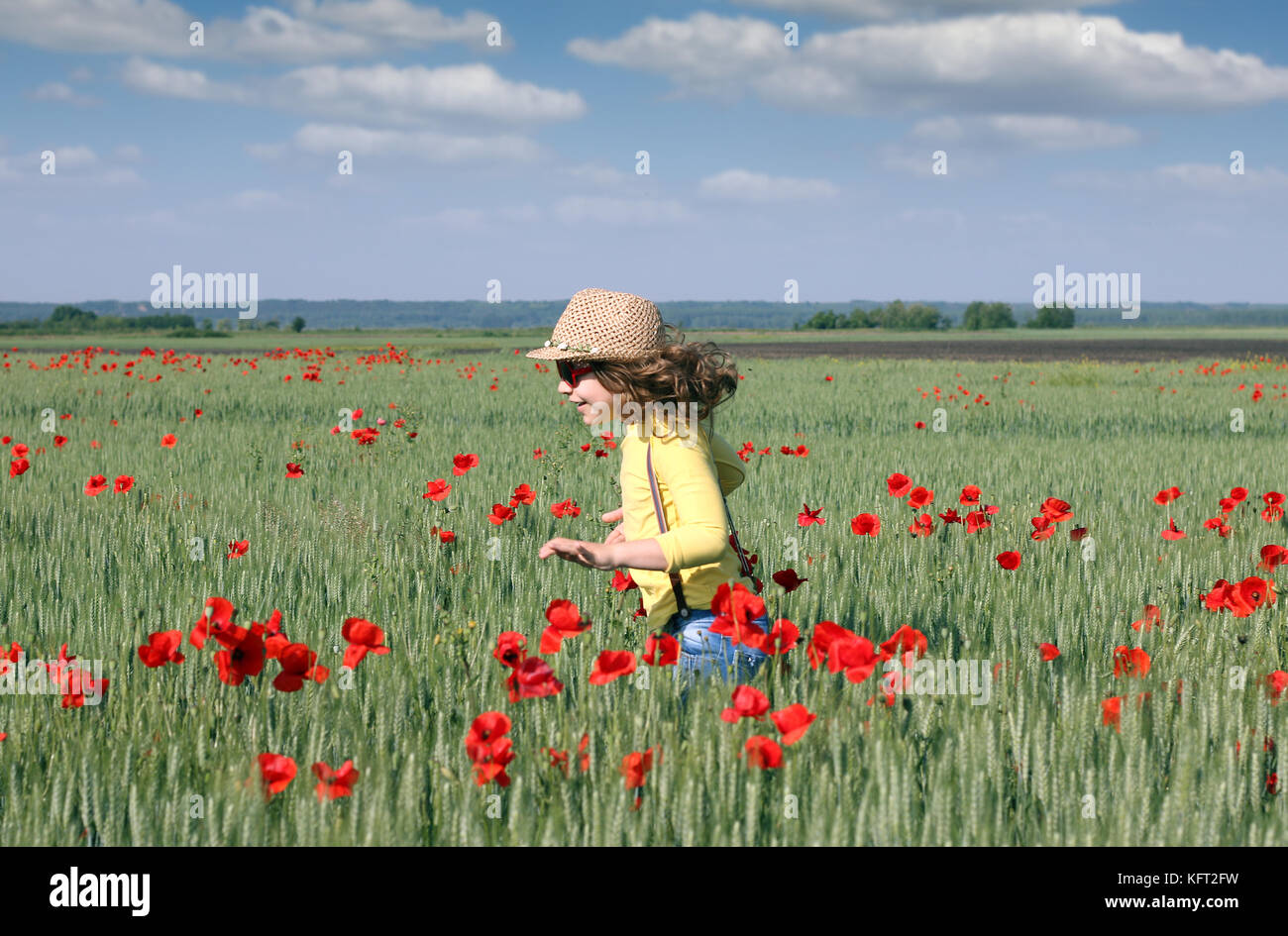 happy little girl running on meadow spring season Stock Photo - Alamy