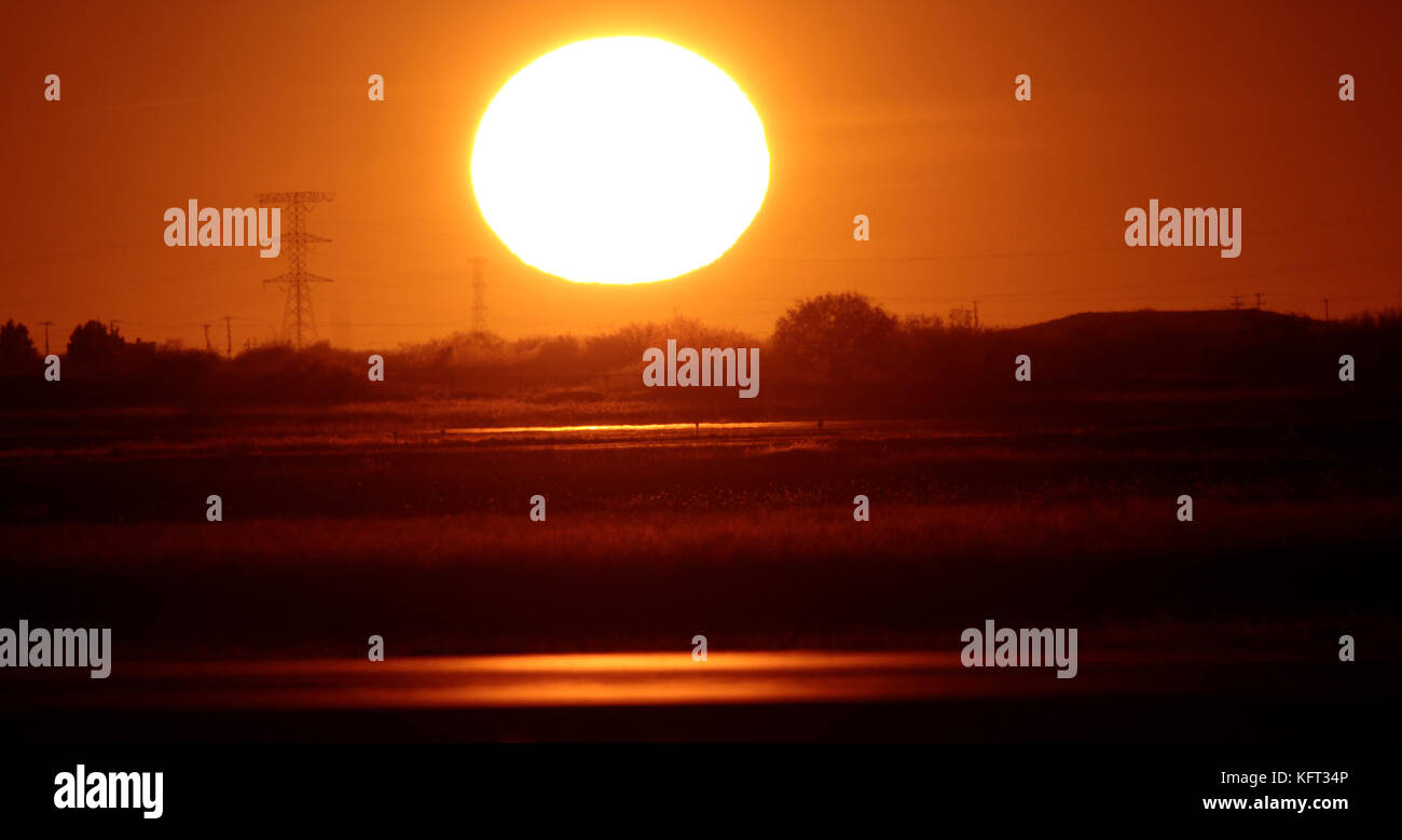 Sun seen at sunset on the horizon to the west of the capital of Sonora, located in the desert northwest of Mexico.    The Sun is a star of spectral ty Stock Photo