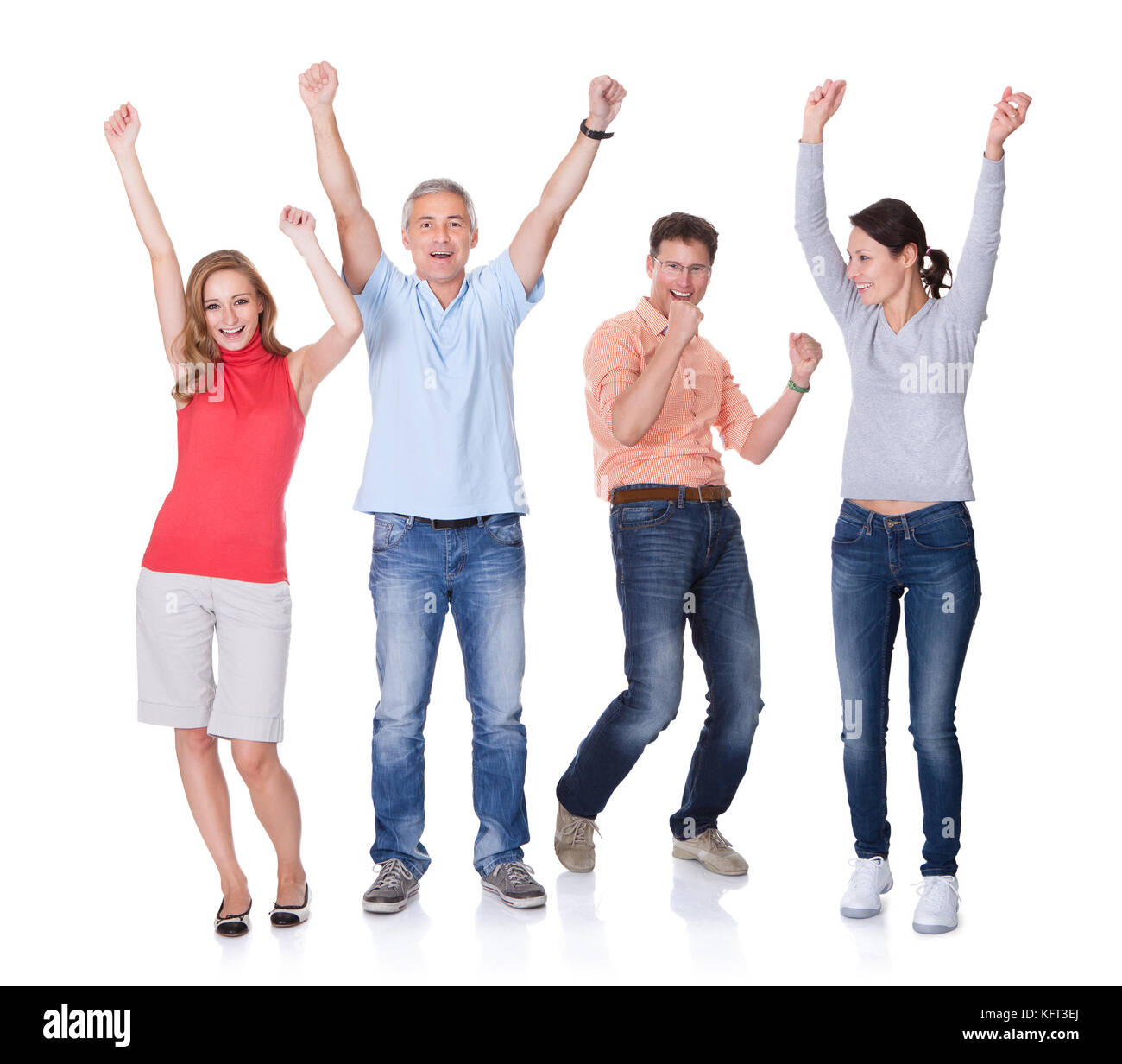 Two happy attractive couples in casual clothes and jeans celebrating raising their arms in the air and shouting on white Stock Photo