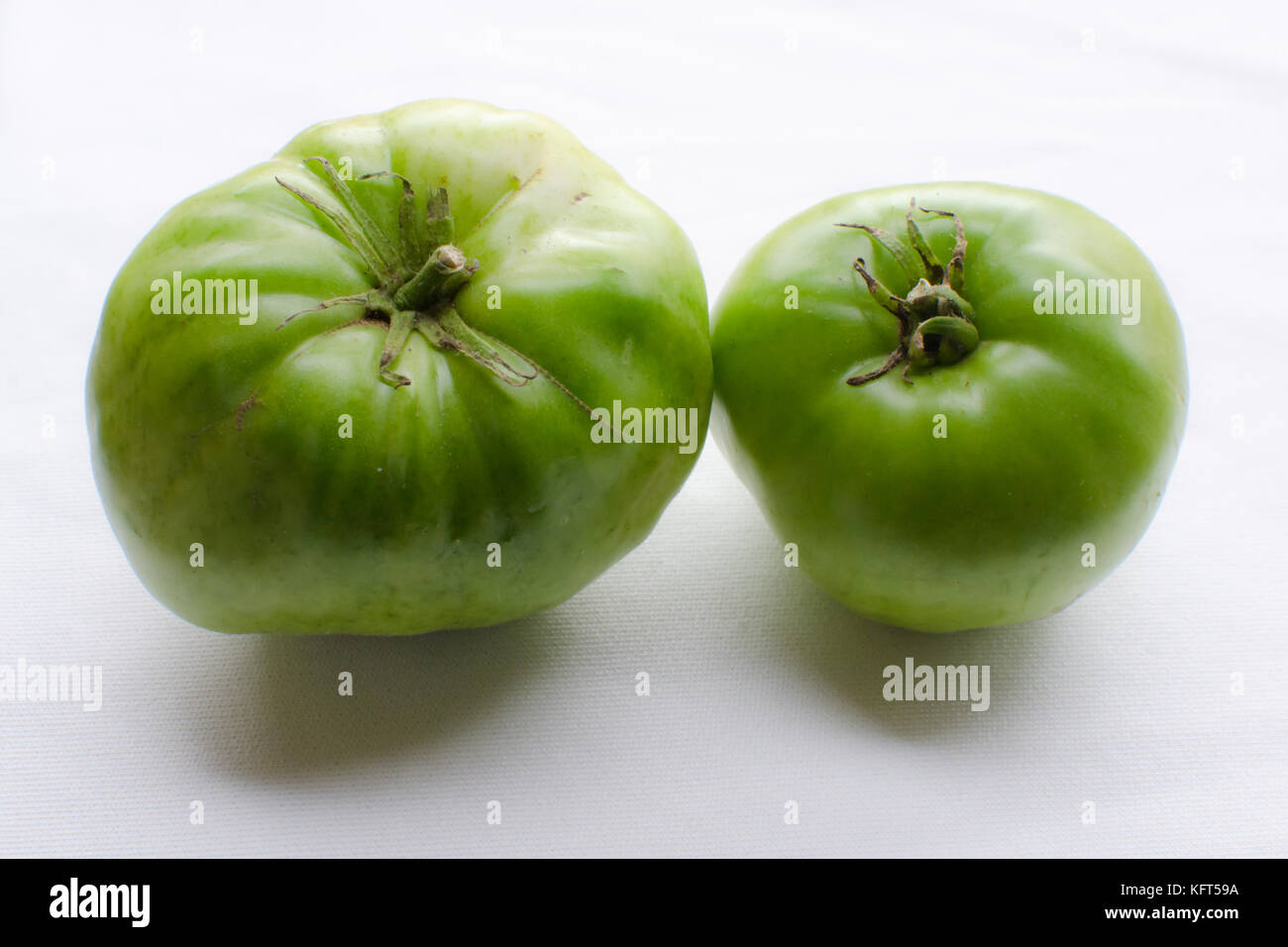 isolated green tomato on white background Stock Photo - Alamy