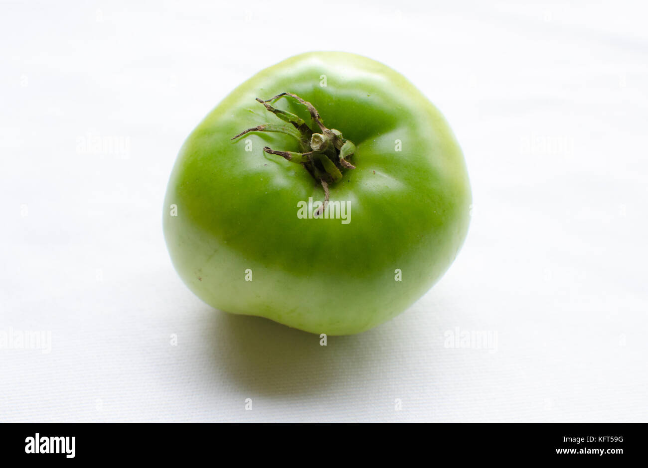 isolated green tomato on white background Stock Photo - Alamy