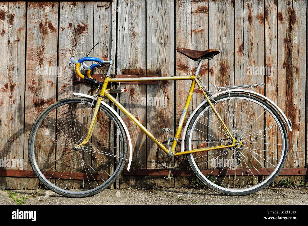 wooden gate. Retro bike parked 