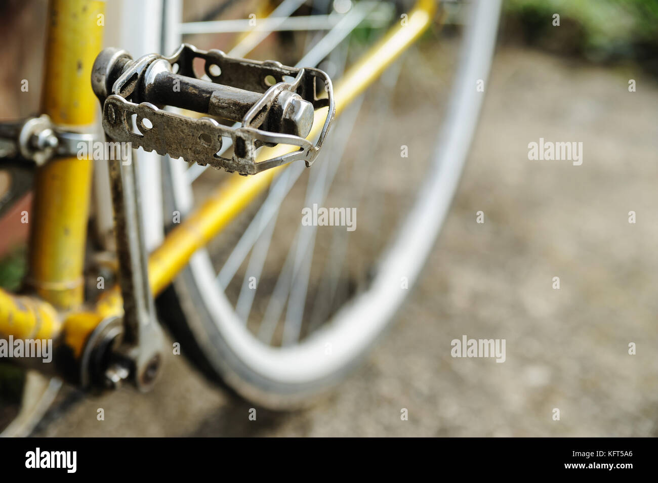 Metal pedal against the background of the rear wheel of a old bicycle. Stock Photo