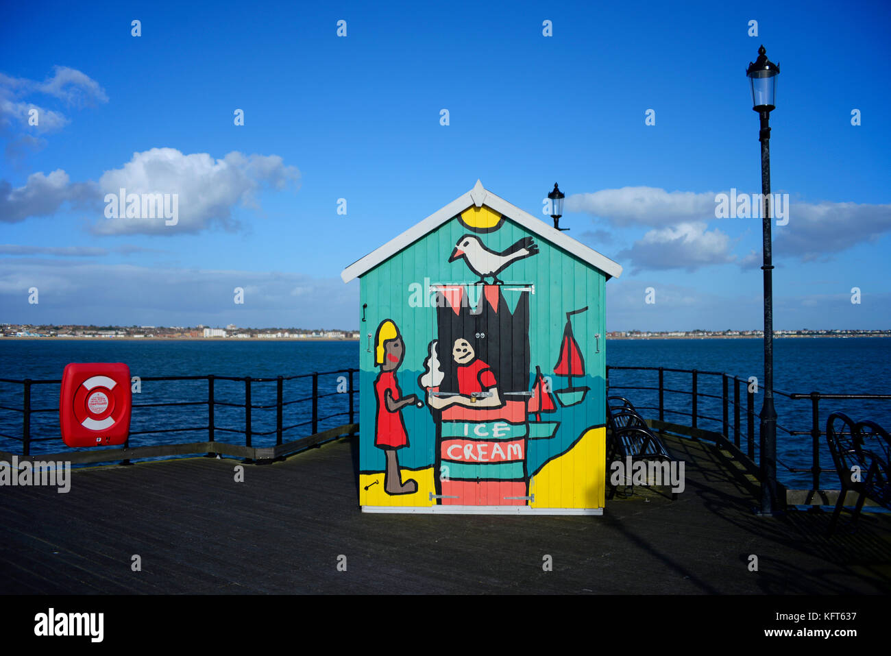 Ice cream hut on Southend Pier with brightly painted seaside scene