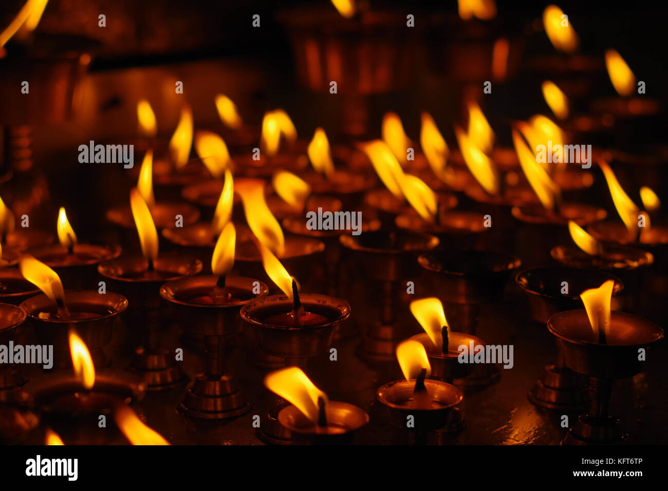 Burning candles in darkness inside temple. Kathmandu, Nepal, Asia Stock Photo