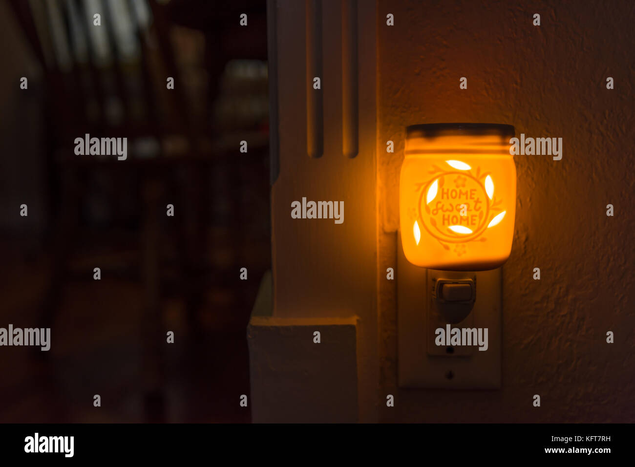 Orange home wax melt in wall outlet Stock Photo Alamy