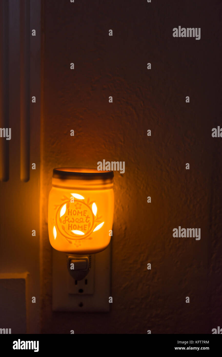 Orange home wax melt in wall outlet Stock Photo Alamy