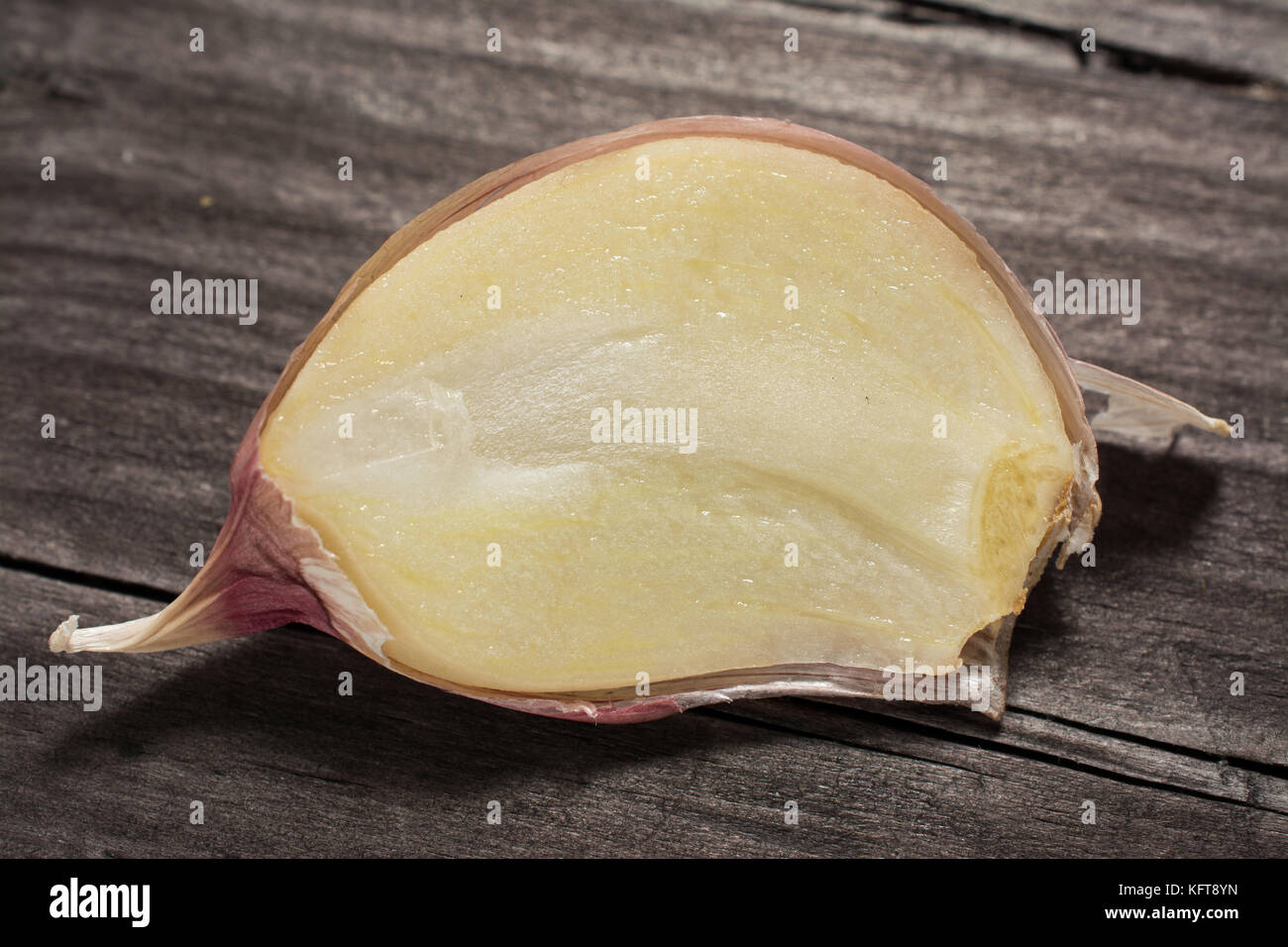 Garlic cloves sliced on wooden vintage background Stock Photo - Alamy