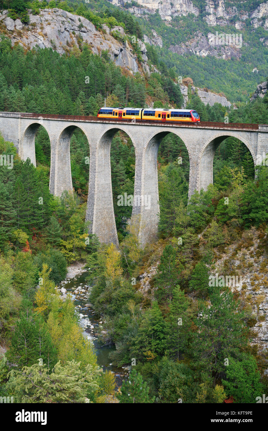 Commuter and sightseeing train on a viaduct over the Coulomp River. Annot, Alpes-de-Haute-Provence, France. Stock Photo