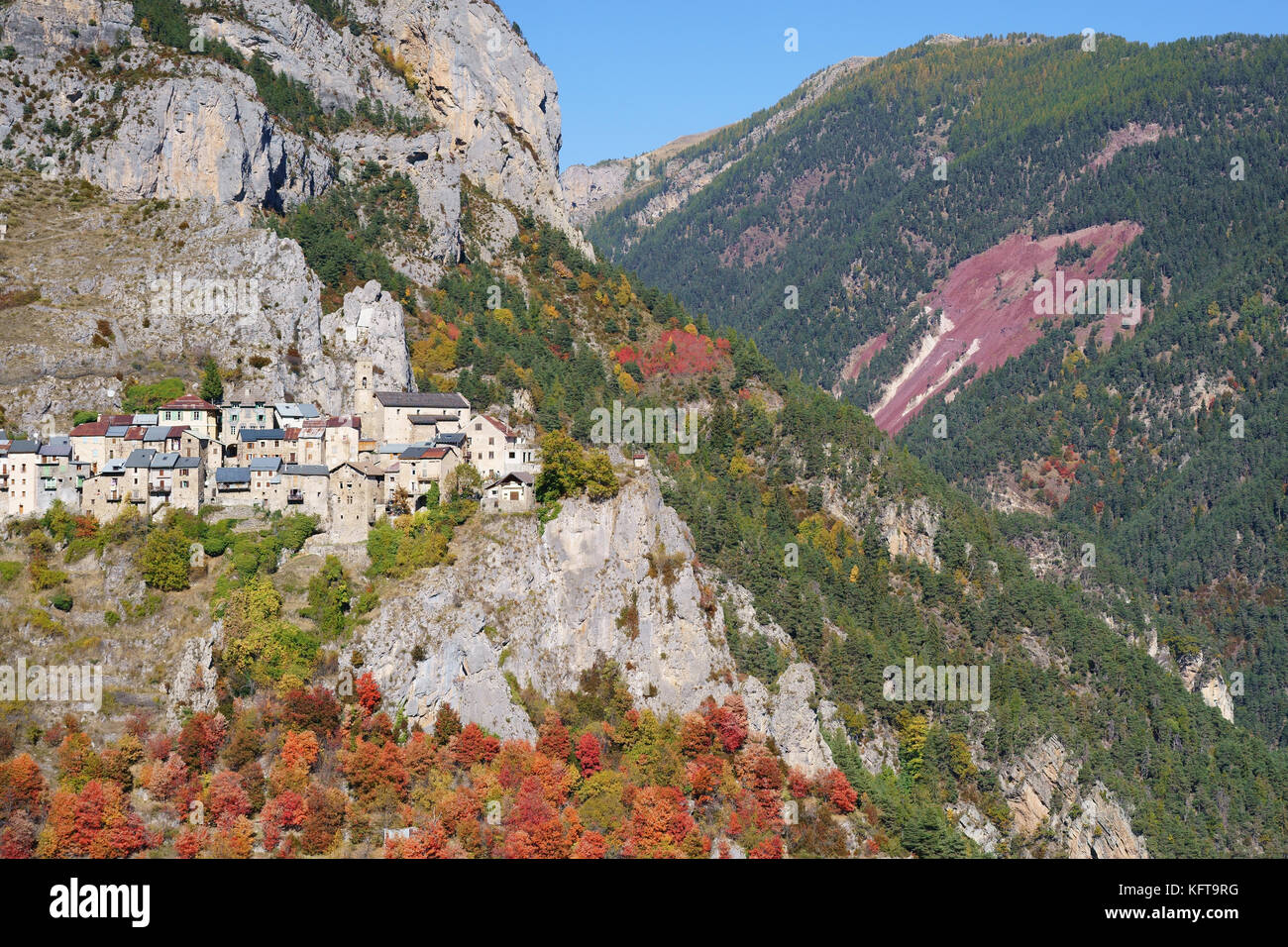 Medieval village in a landscape of cliffs and forest with autumnal colors. Roubion, French Riviera's hinterland, Alpes-Maritimes, France. Stock Photo