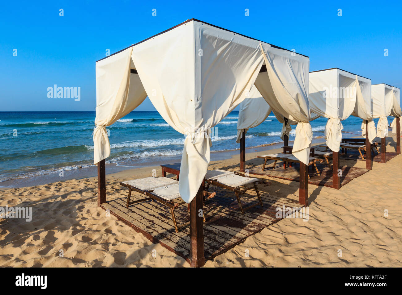 Luxury beach tents canopies on morning paradise white sandy beach