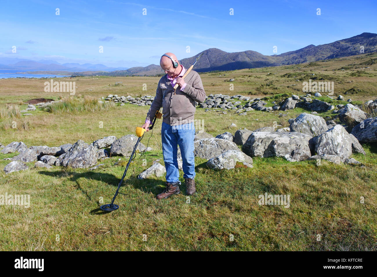 Mature male metal detecting in an Irish Landscape John Gollop Stock