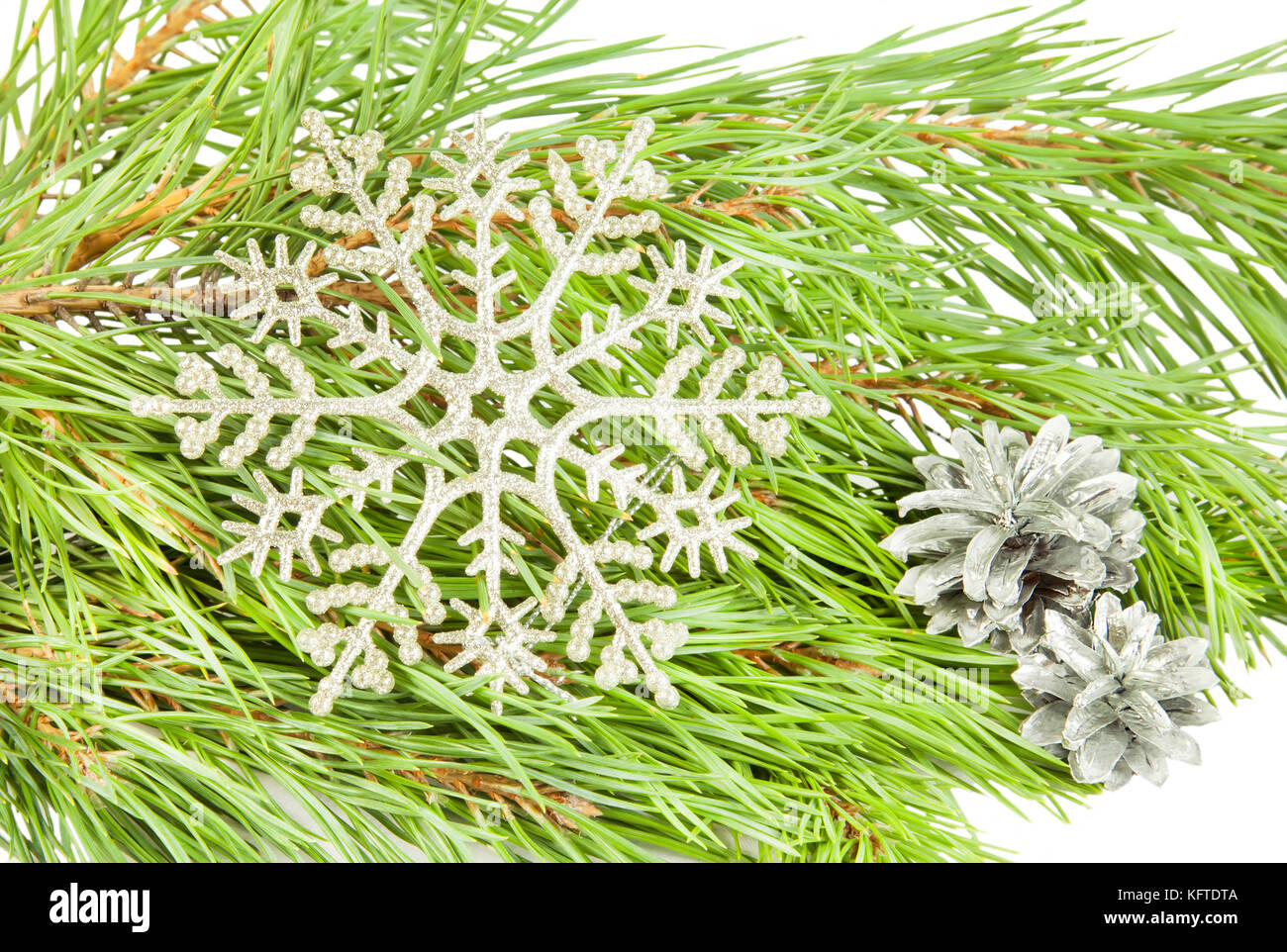 Artificial new year snowflake on fir tree branch background Stock Photo