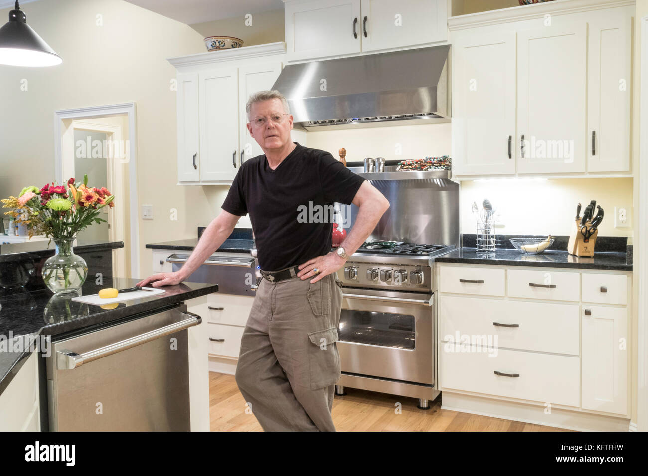 Senior Man in Showcase Kitchen, USA Stock Photo