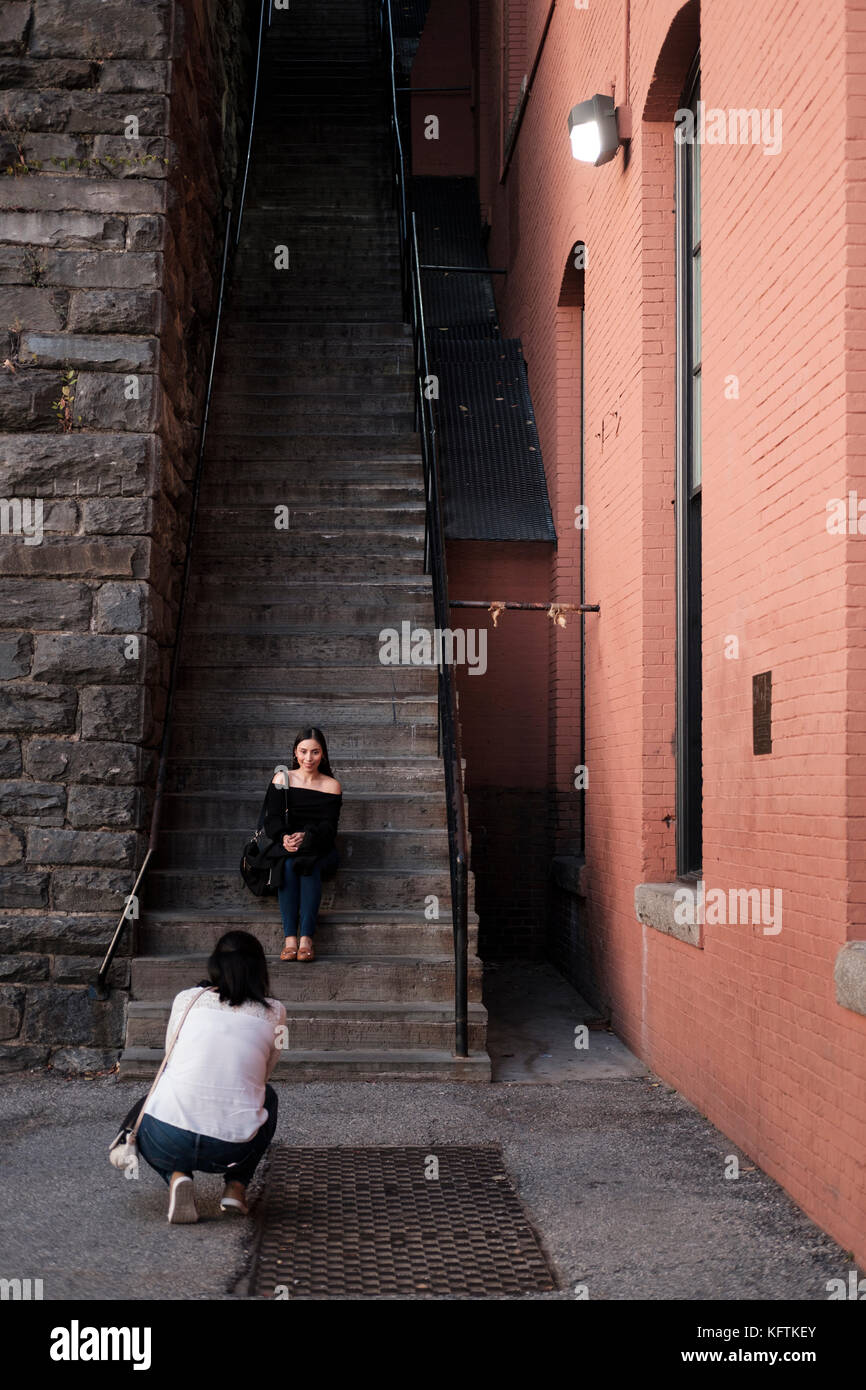 Tourists posing for a photo at The Exorcist Steps, staircase movie location for the film The Exorcist, Prospect St NW in Georgetown, Washington D.C.,  Stock Photo