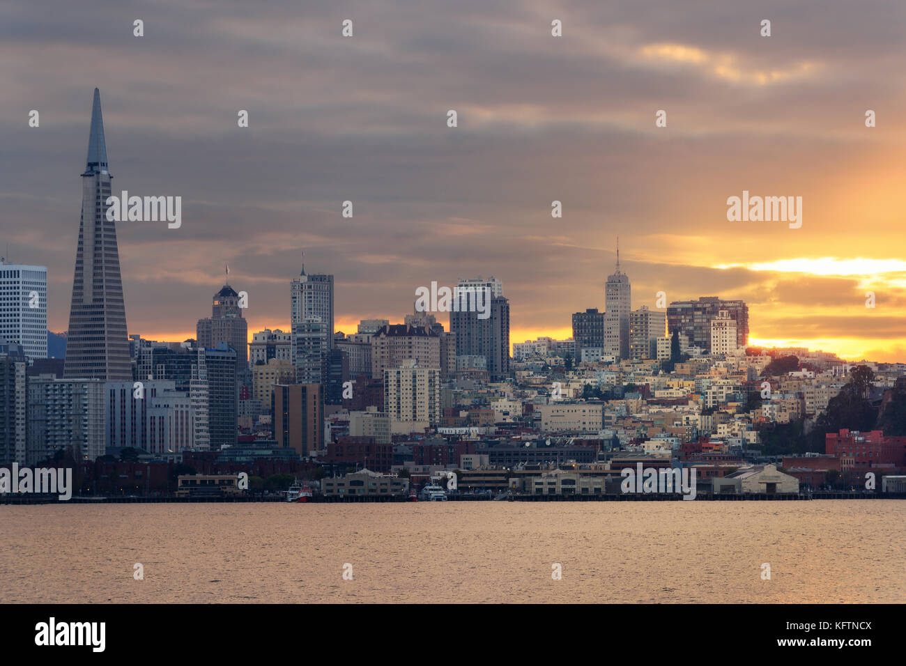 Skyline of Bay Area in San Francisco, California. Panorama of Bay Bridge and big city after sunset. Stock Photo