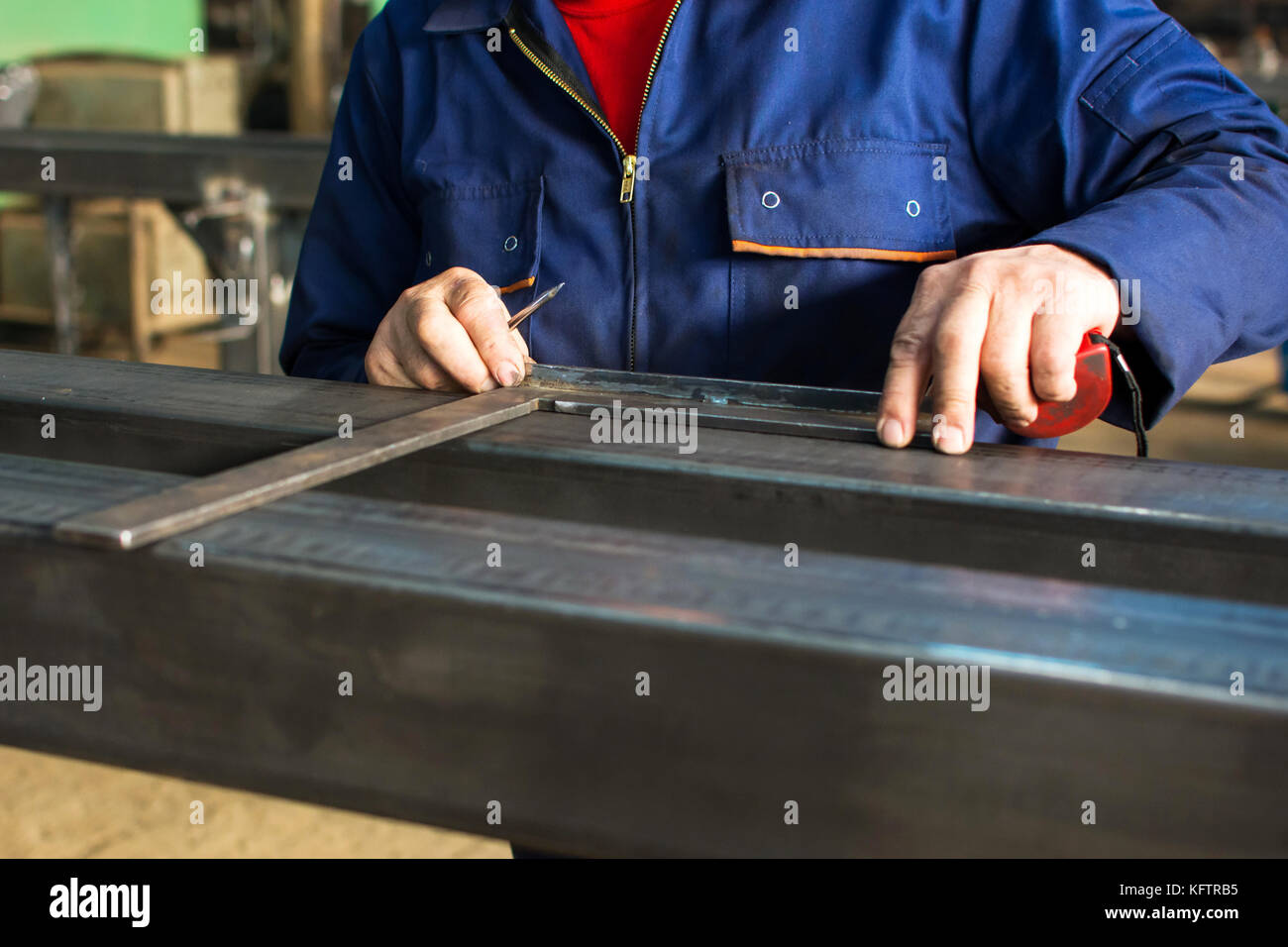 Worker measuring fresh welded stainless steel bar Stock Photo Alamy