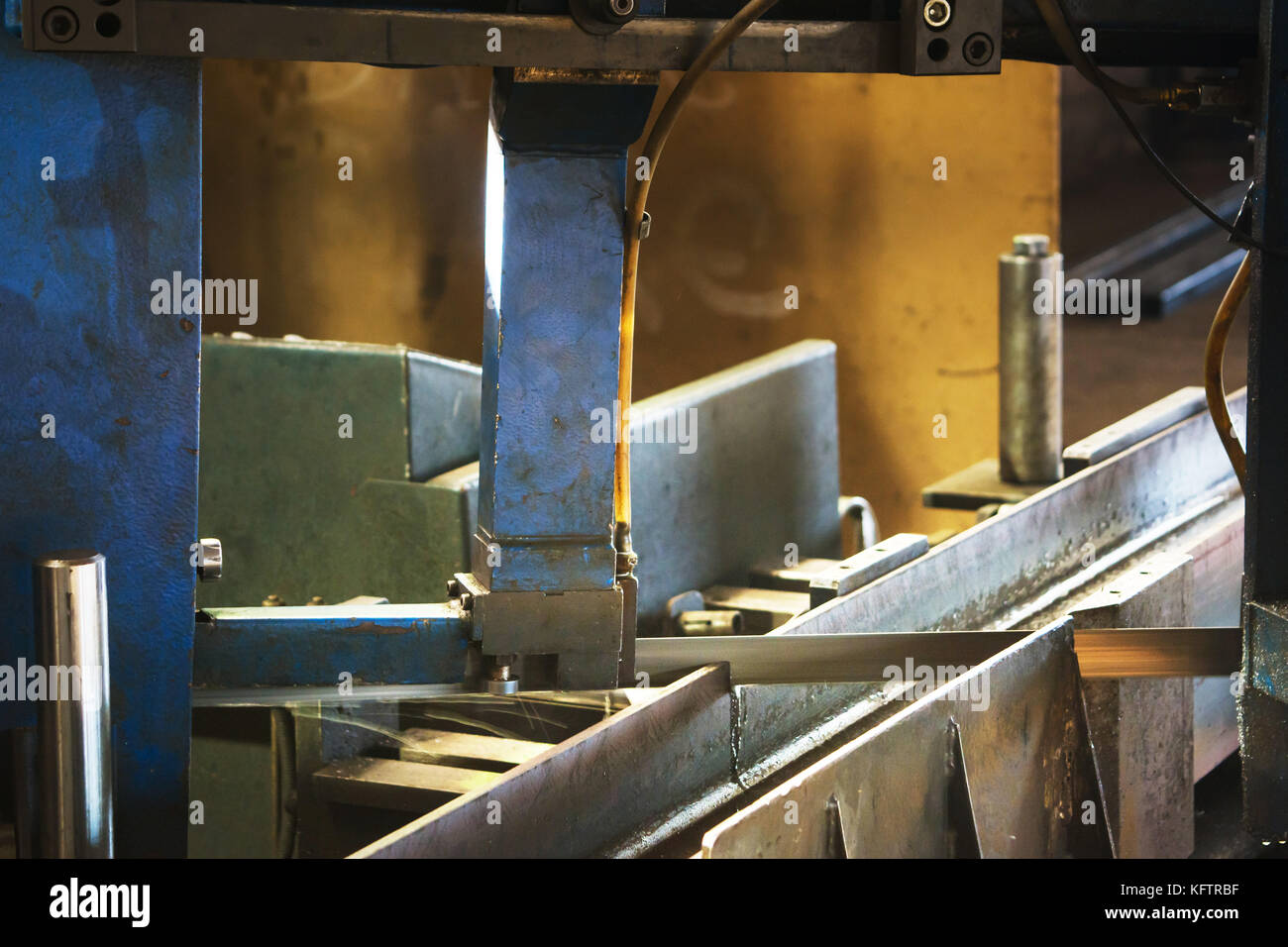 Automated saw cutting stainless steel cooled with water Stock Photo Alamy