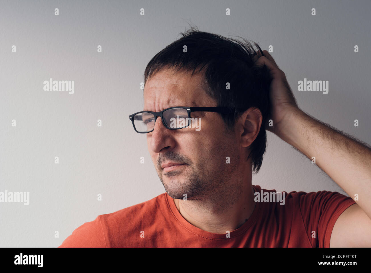 Forgetful absent-minded man is trying to remember something  that he managed to forget. Stock Photo