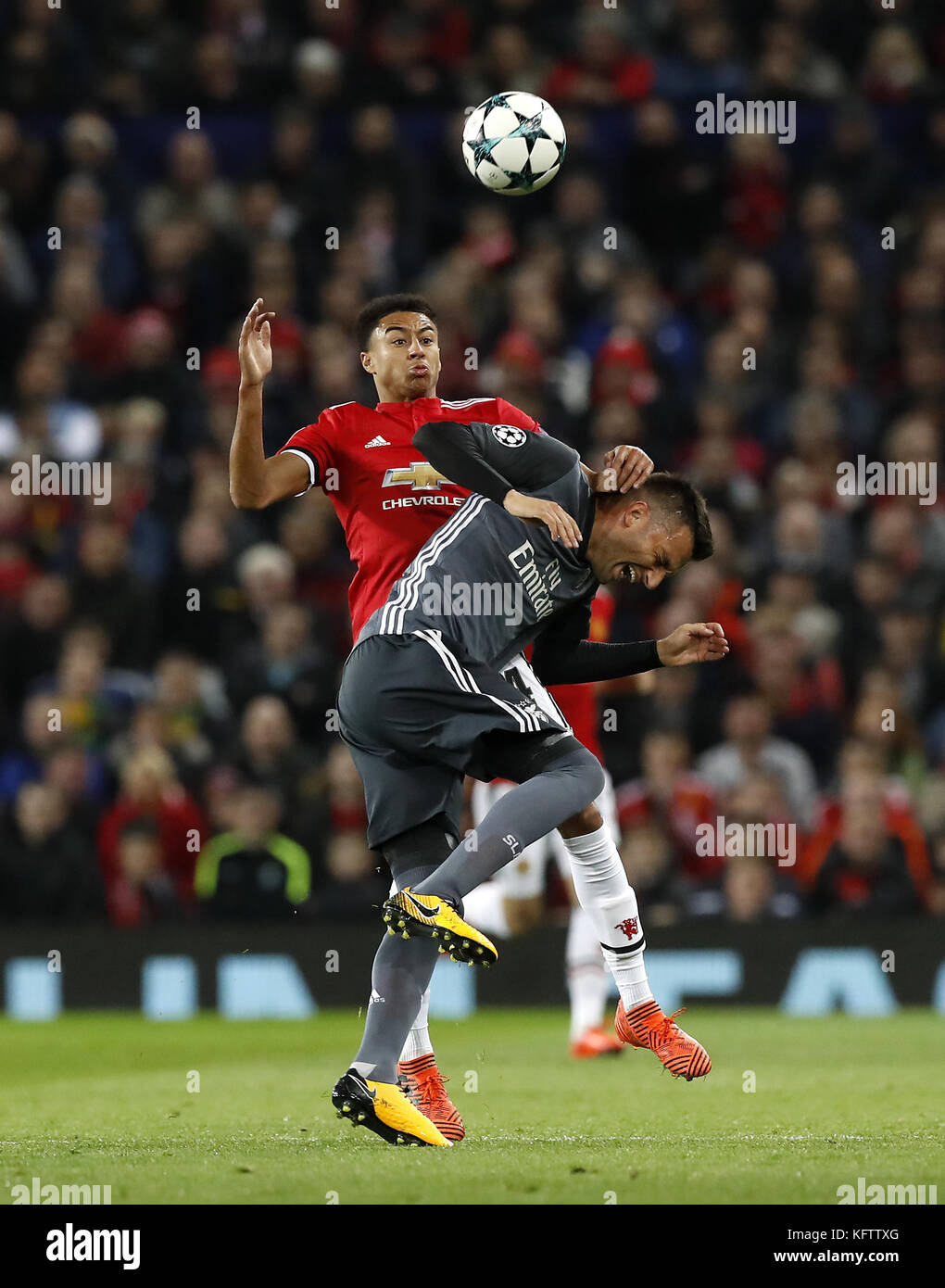 Benfica's Andreas Samaris (left) and Manchester United's Jesse Lingard (right) battle for the ball during the UEFA Champions League, Group A match at Old Trafford, Manchester. Stock Photo