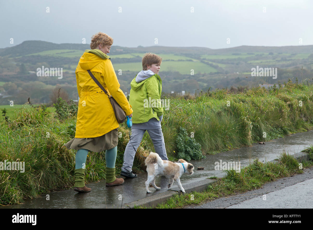 family walking dog, Ballintoy, Co. Antrim, Northern Ireland Stock Photo