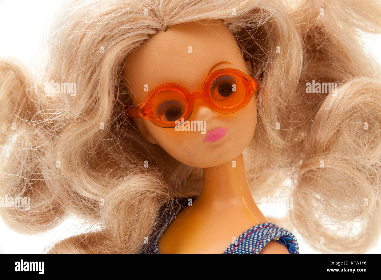 Vintage 1970's plastic doll with big blonde hair, wearing sunglasses and a summer dress Stock Photo